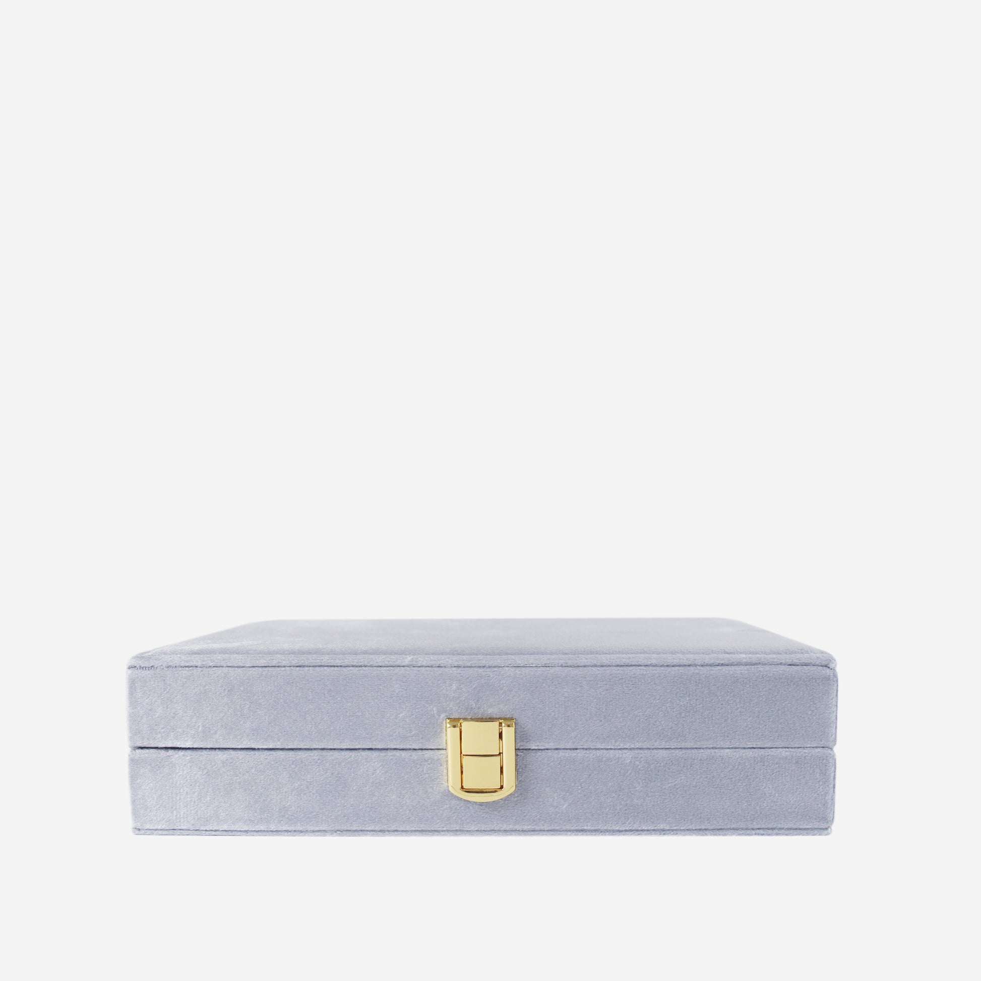 Blue velvet closed jewellery box on an off white background