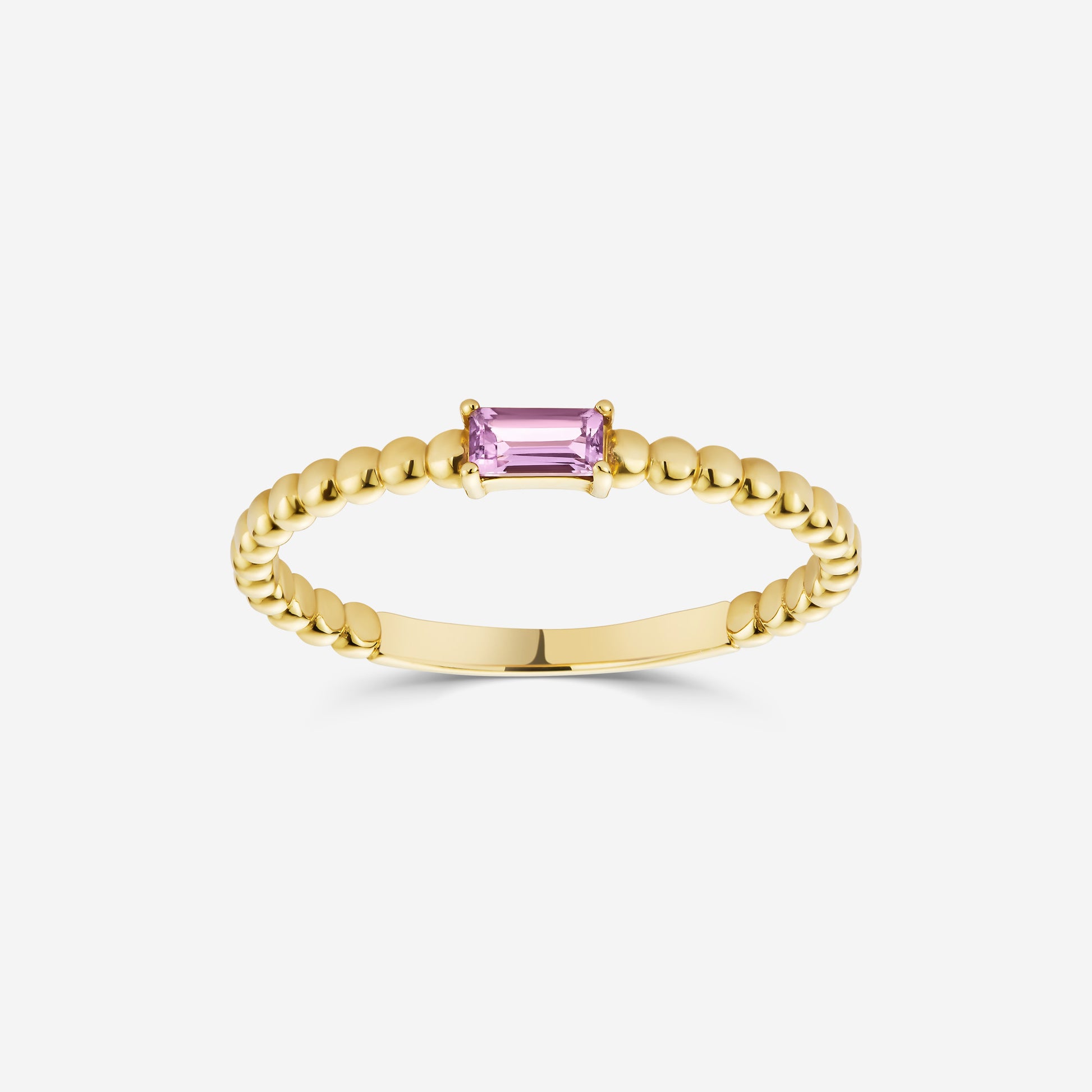 14ct yellow gold beaded ring with an amethyst gemstone on an off white background