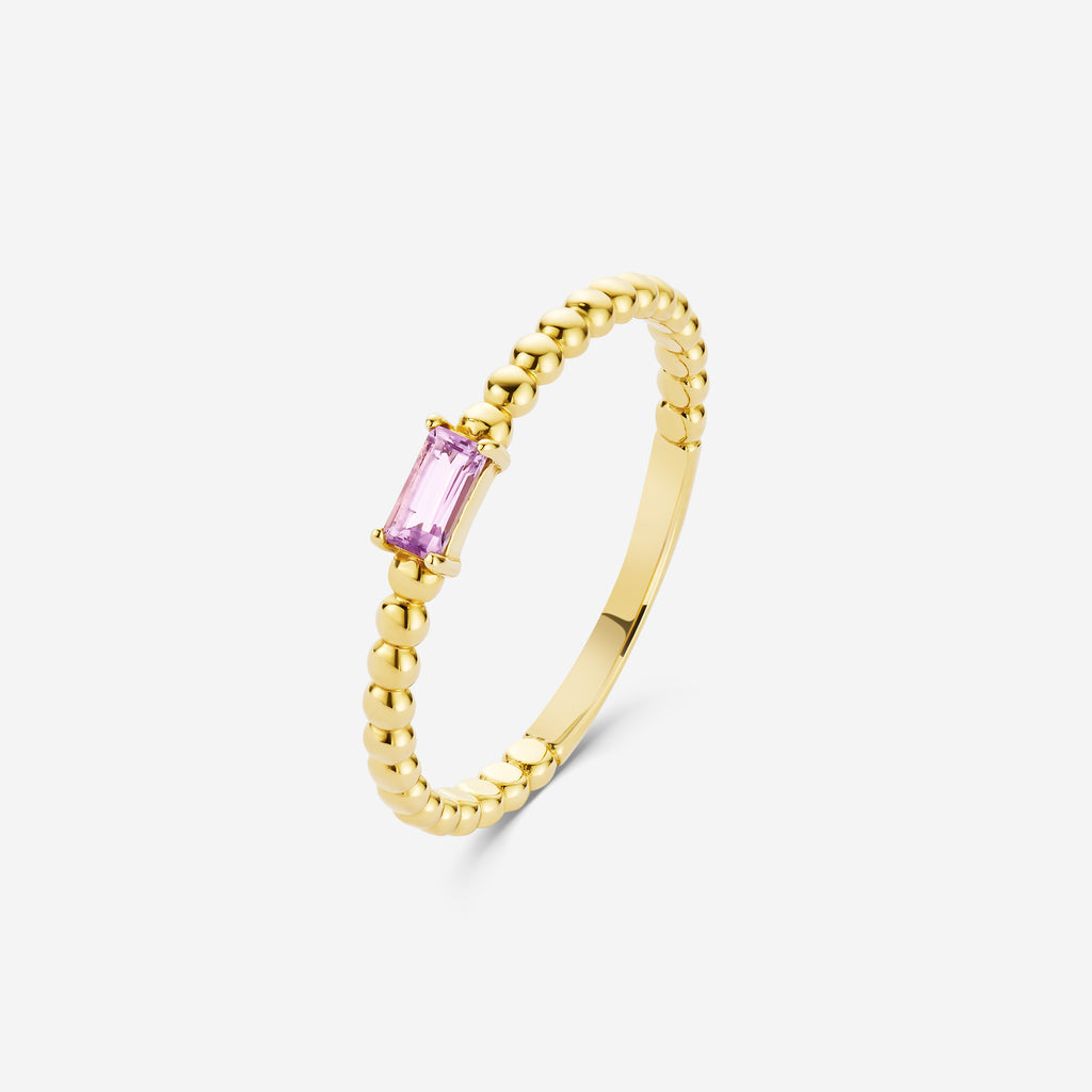 14ct yellow gold beaded ring with an amethyst gemstone on an off white background