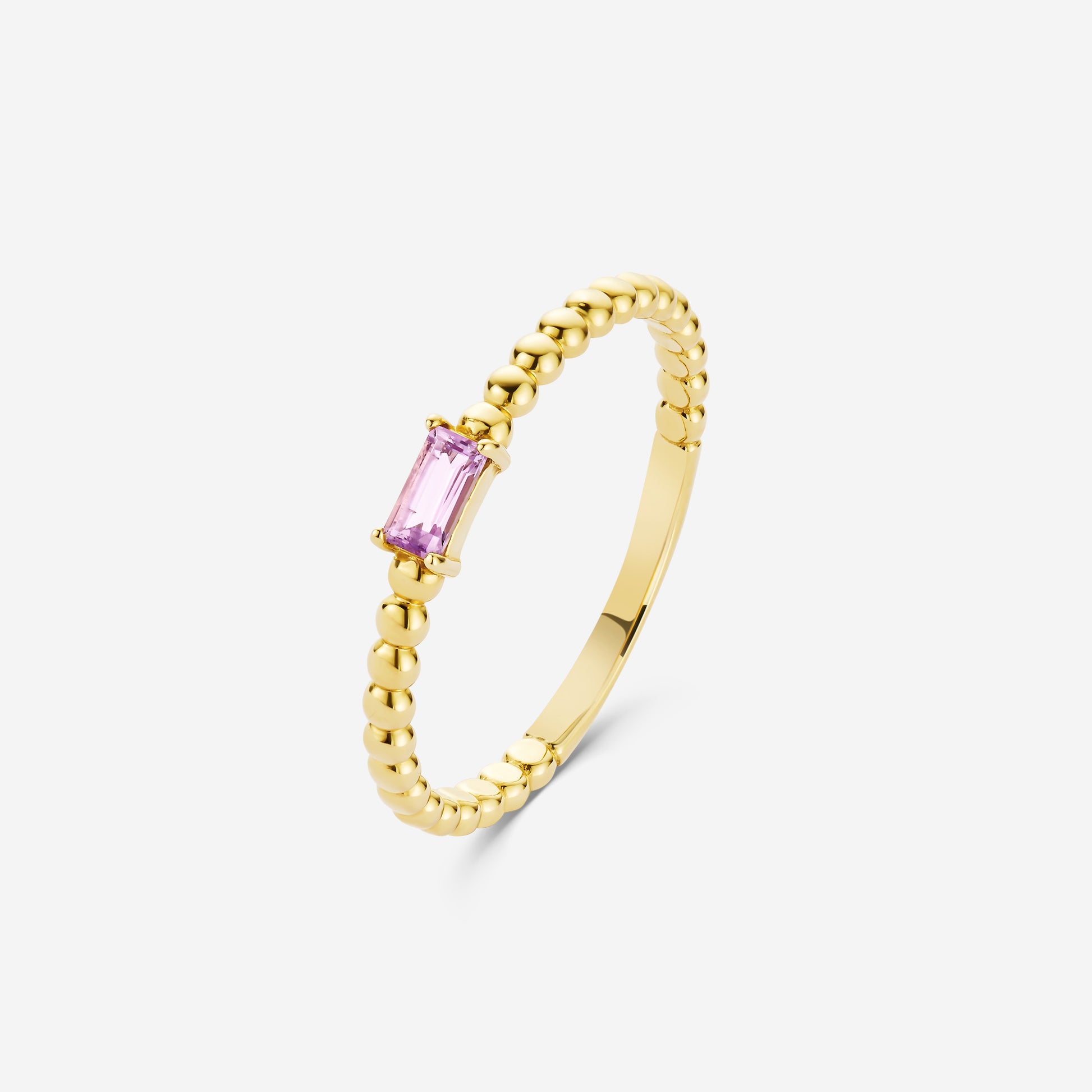 14ct yellow gold beaded ring with an amethyst gemstone on an off white background