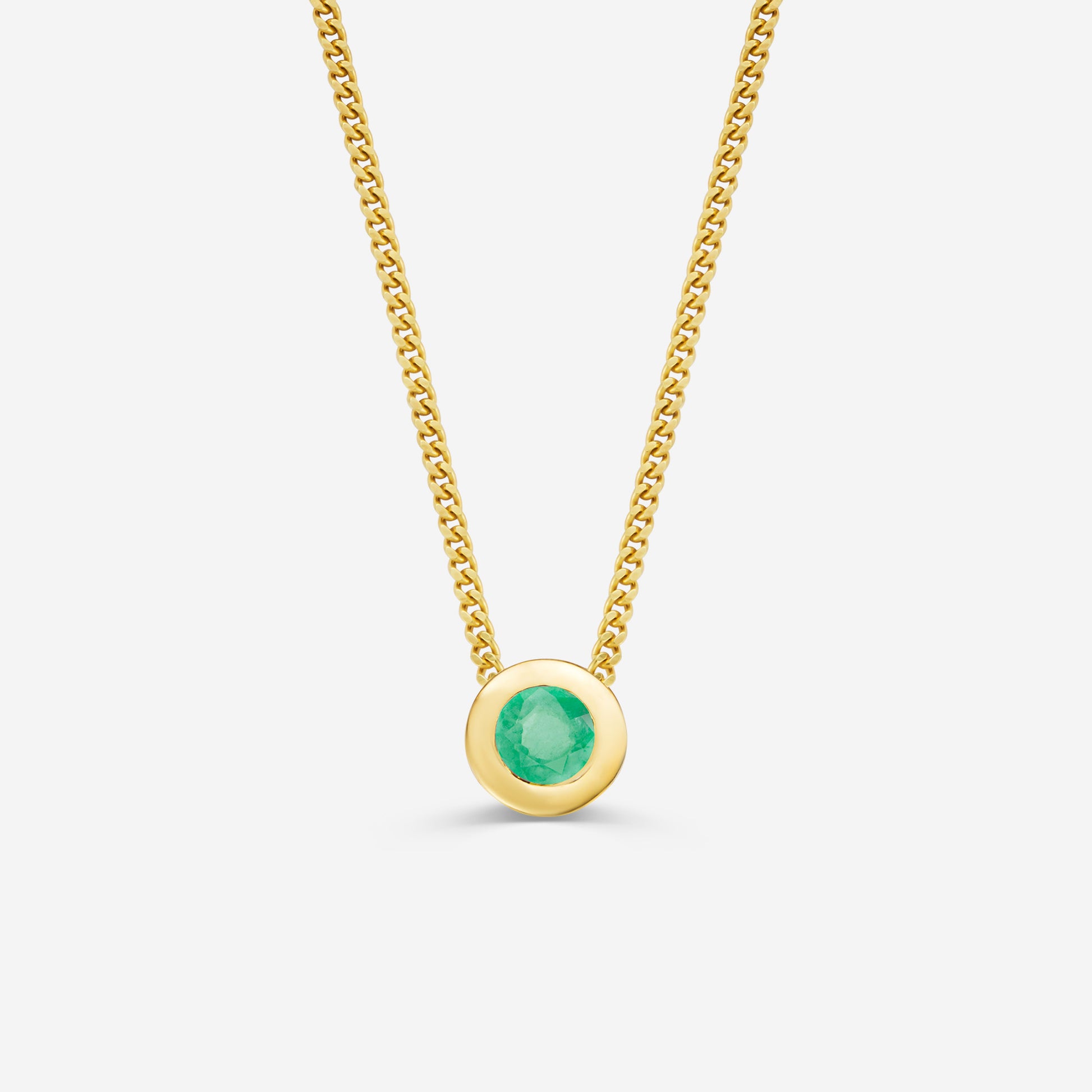 9ct yellow gold necklace with a round emerald pendant on an off white background
