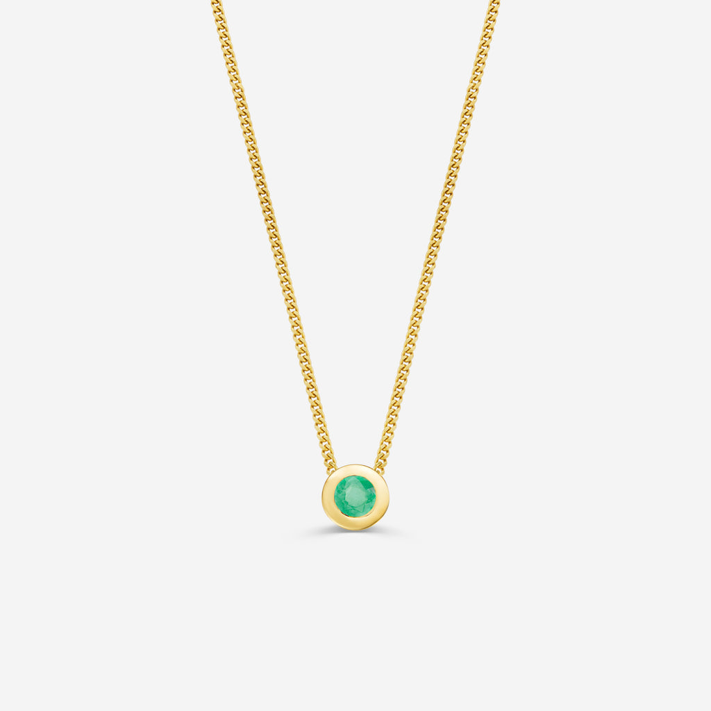 9ct yellow gold necklace with a round emerald pendant on an off white background