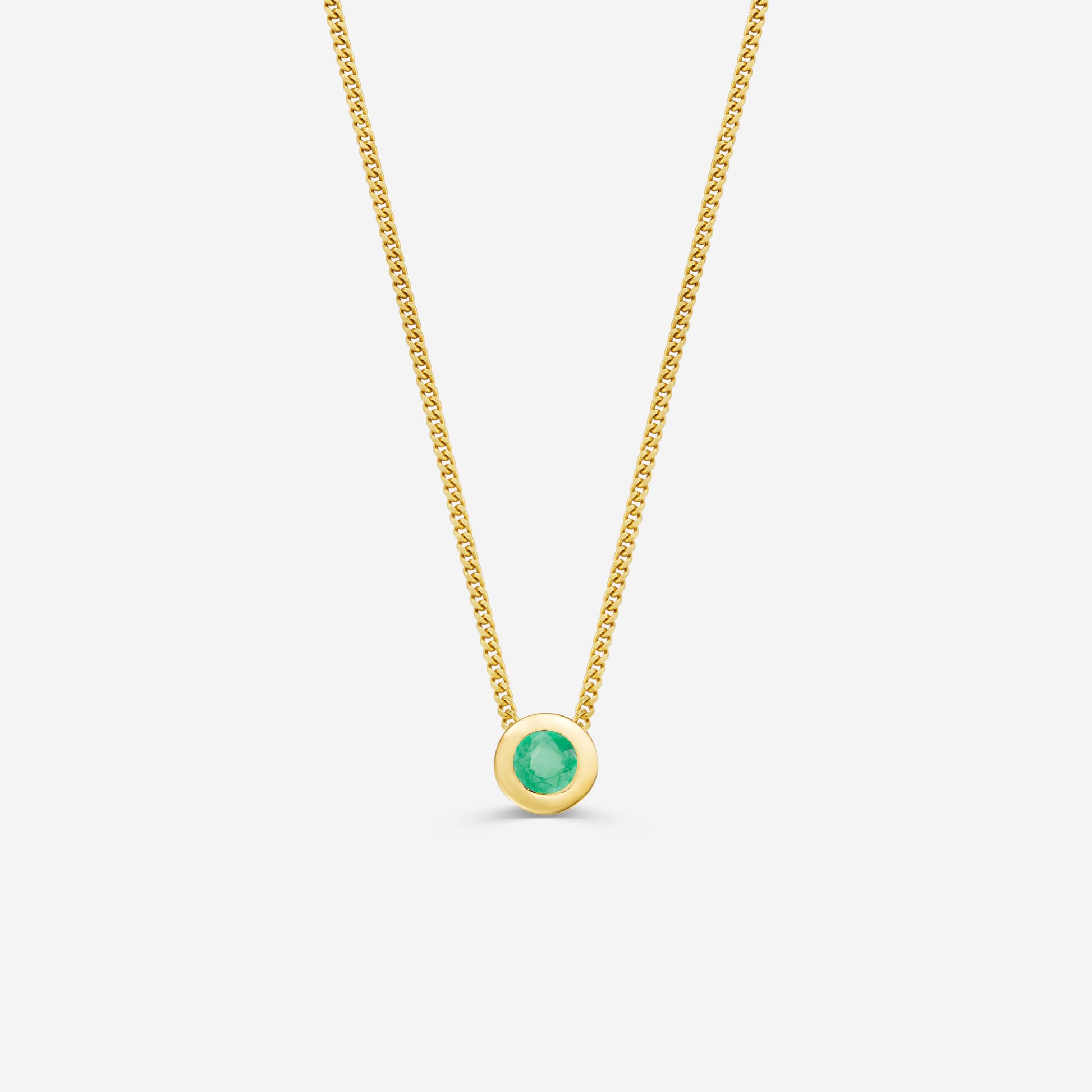 9ct yellow gold necklace with a round emerald pendant on an off white background
