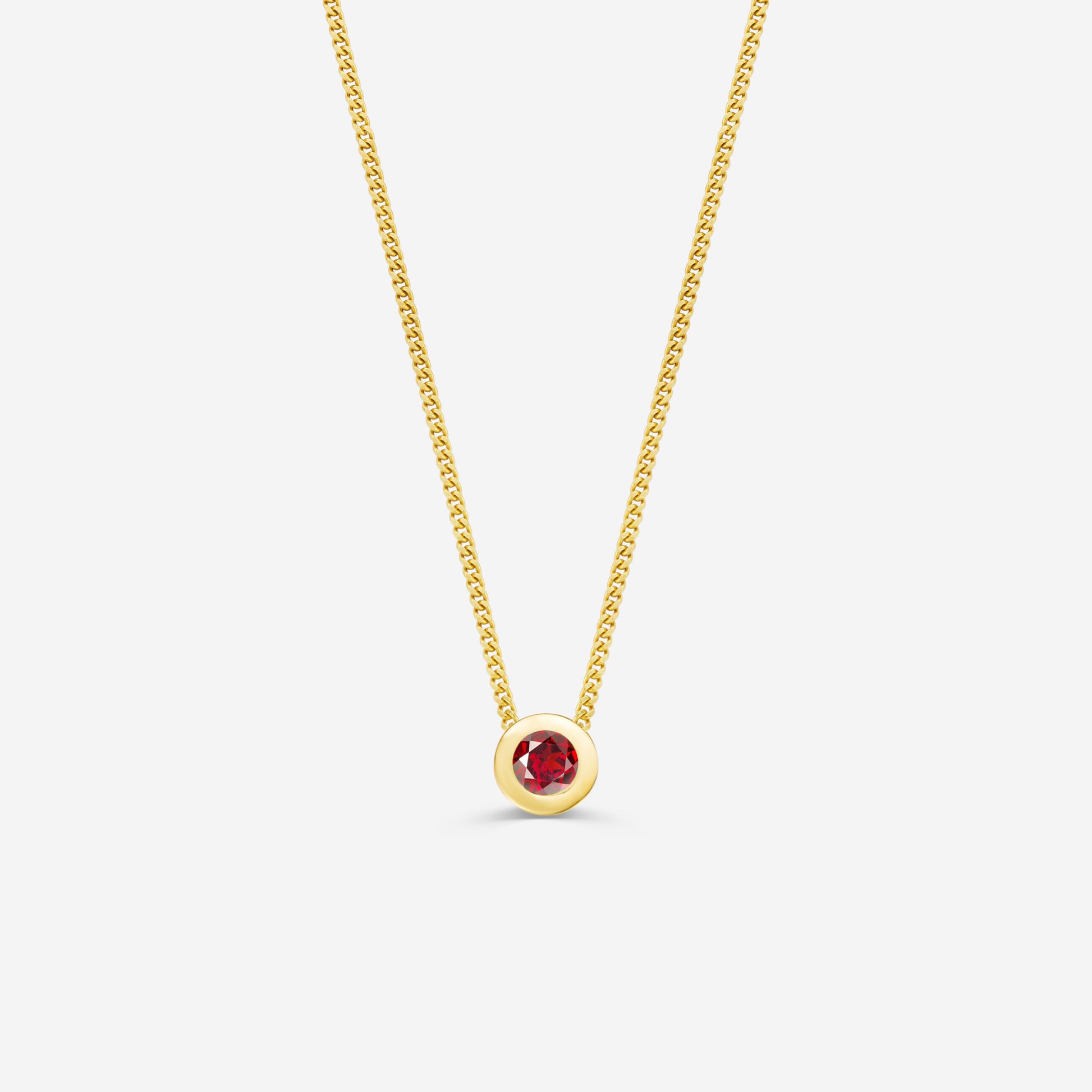 9ct yellow gold necklace with a round garnet pendant on an off white background