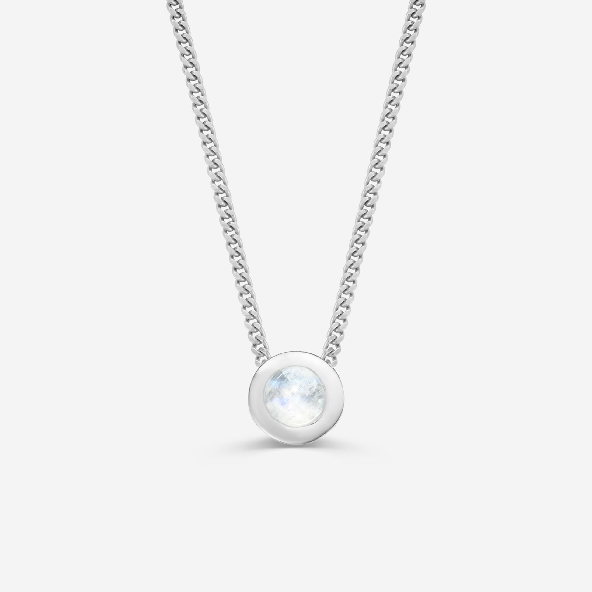 9ct white gold necklace with a round moonstone pendant on an off white background