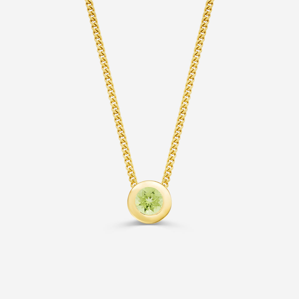 9ct yellow gold necklace with a round peridot pendant on an off white background