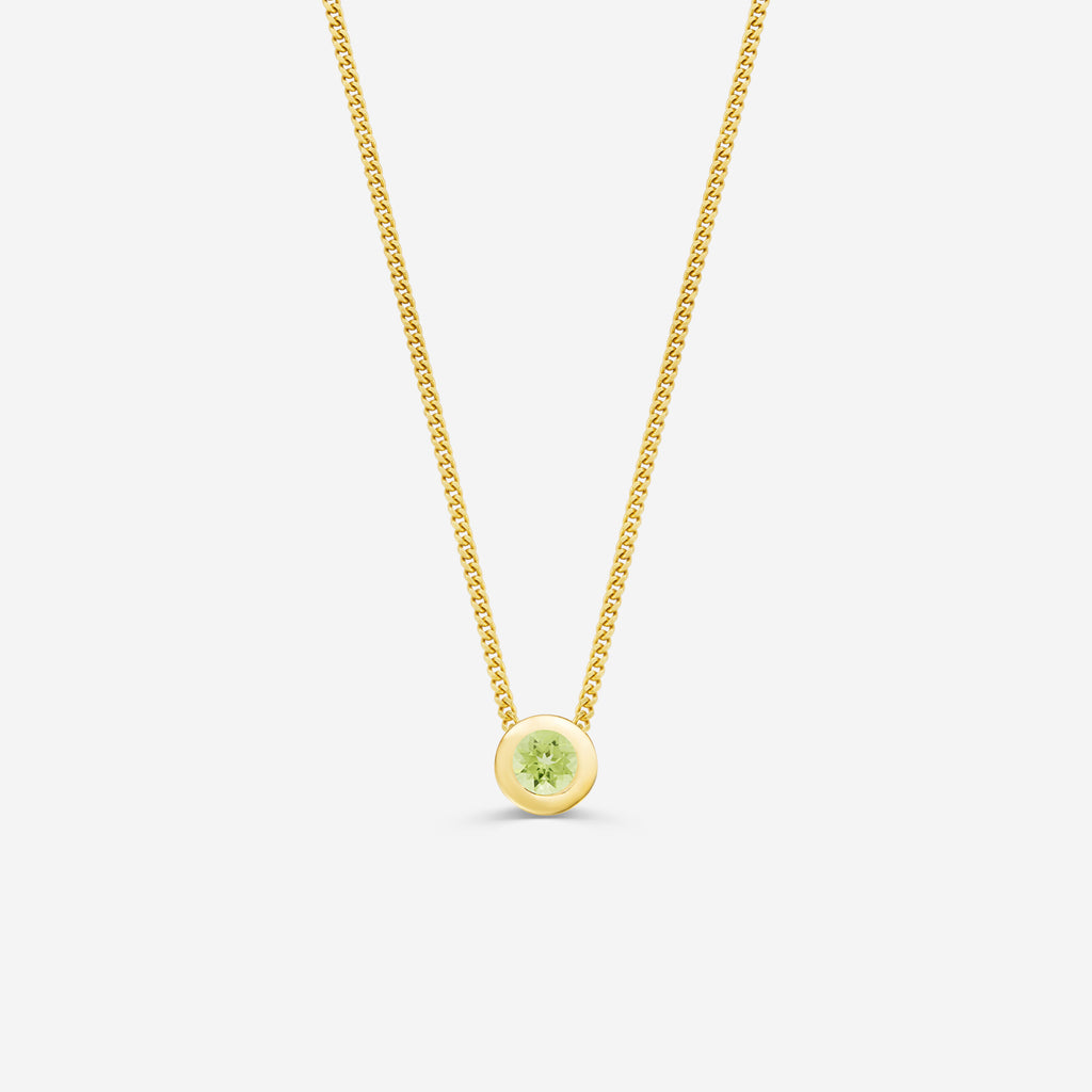 9ct yellow gold necklace with a round peridot pendant on an off white background