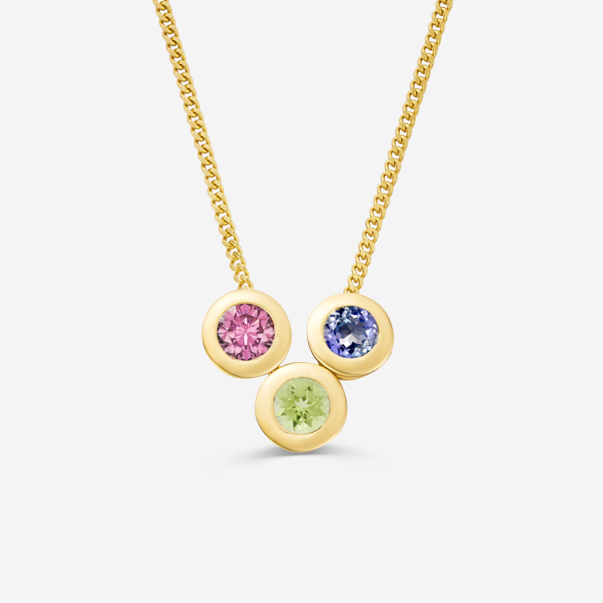 9ct yellow gold necklace with three round gemstone pendants on an off white background