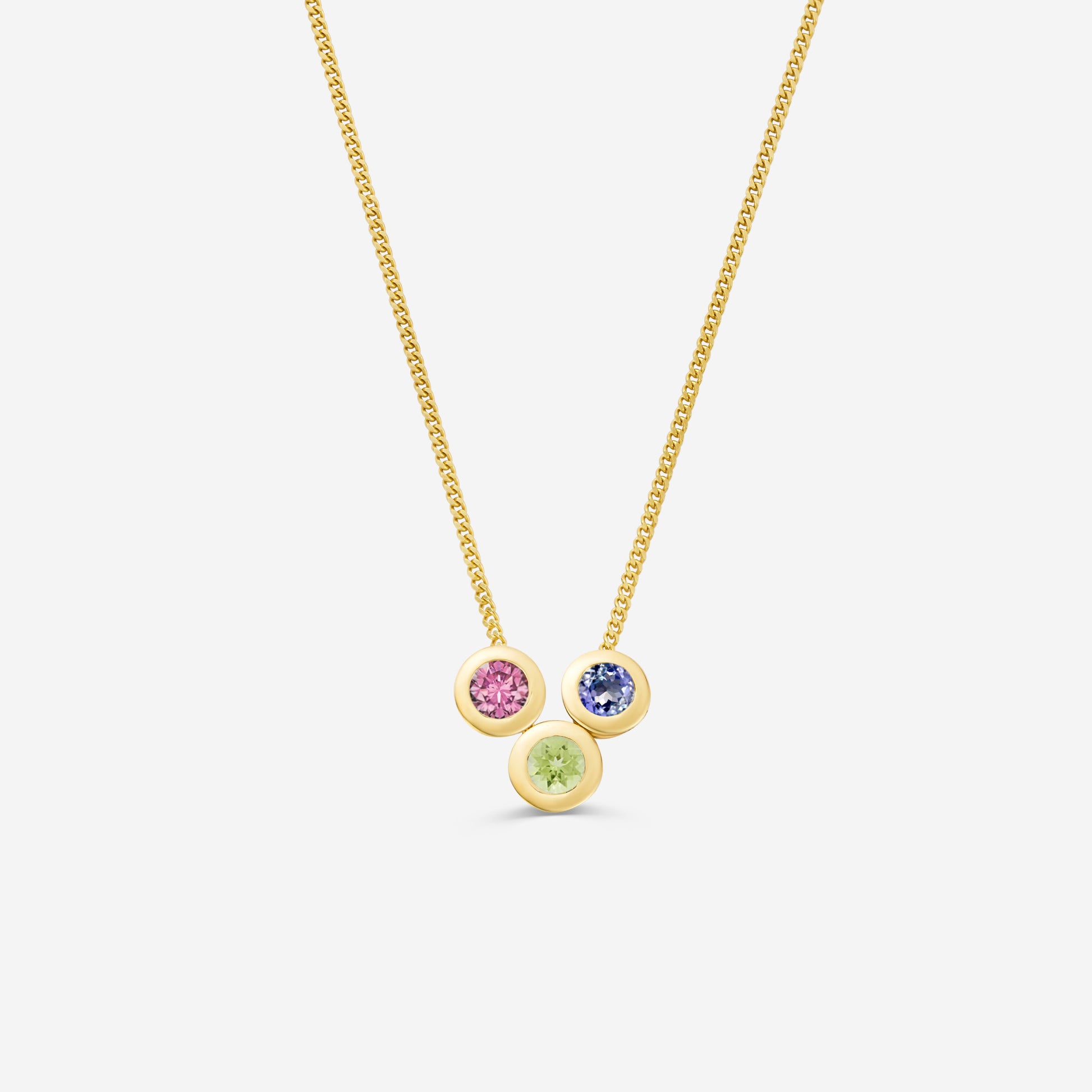 9ct yellow gold necklace with three round gemstone pendants on an off white background