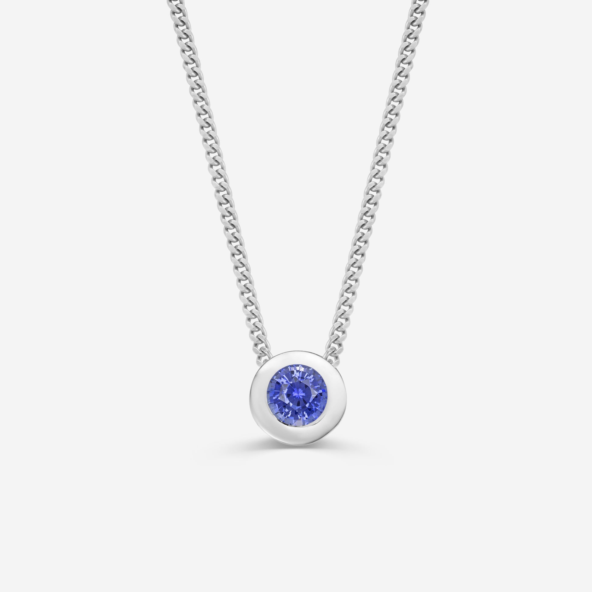9ct white gold necklace with a round sapphire  pendant on an off white background