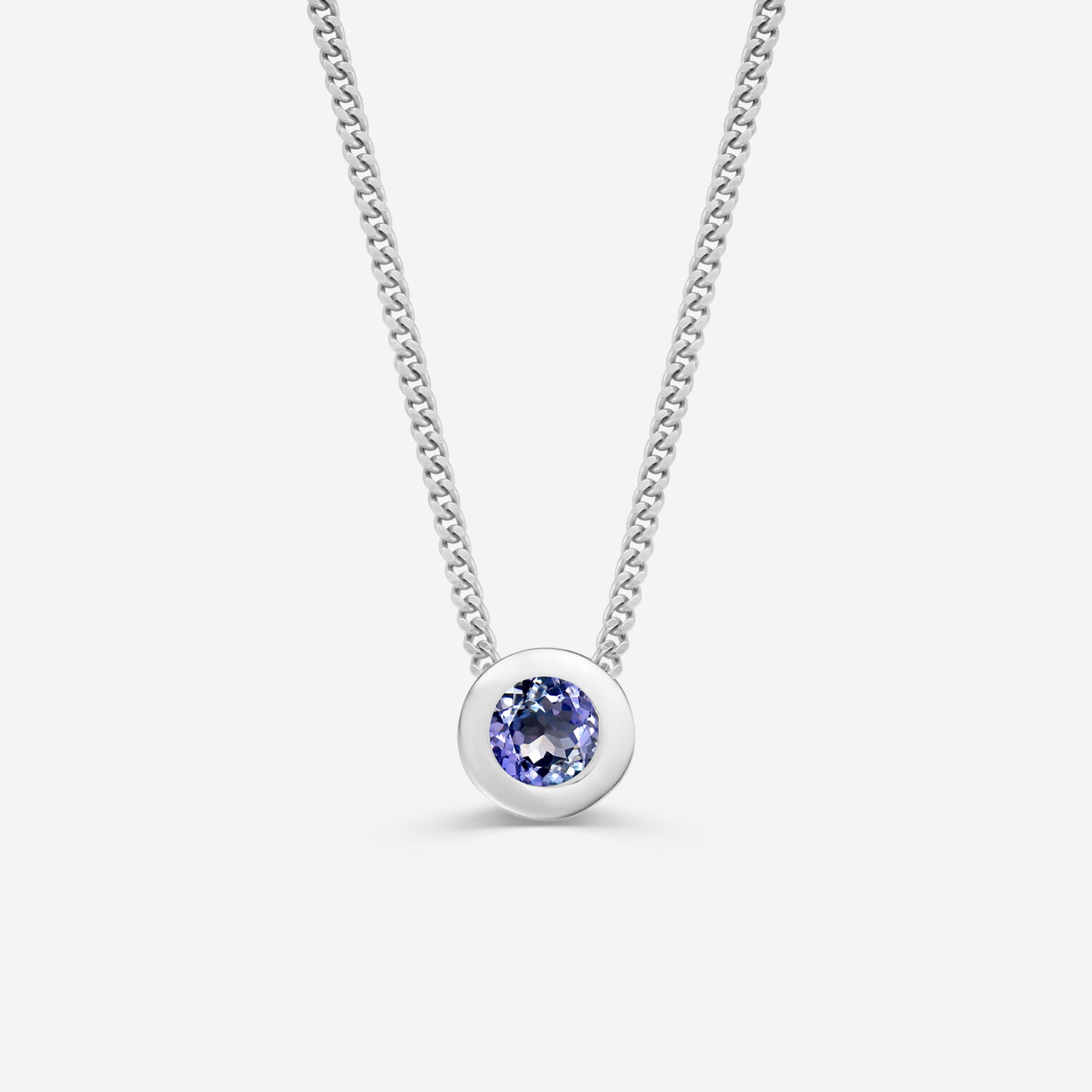 9ct white gold necklace with a round tanzanite pendant on an off white background