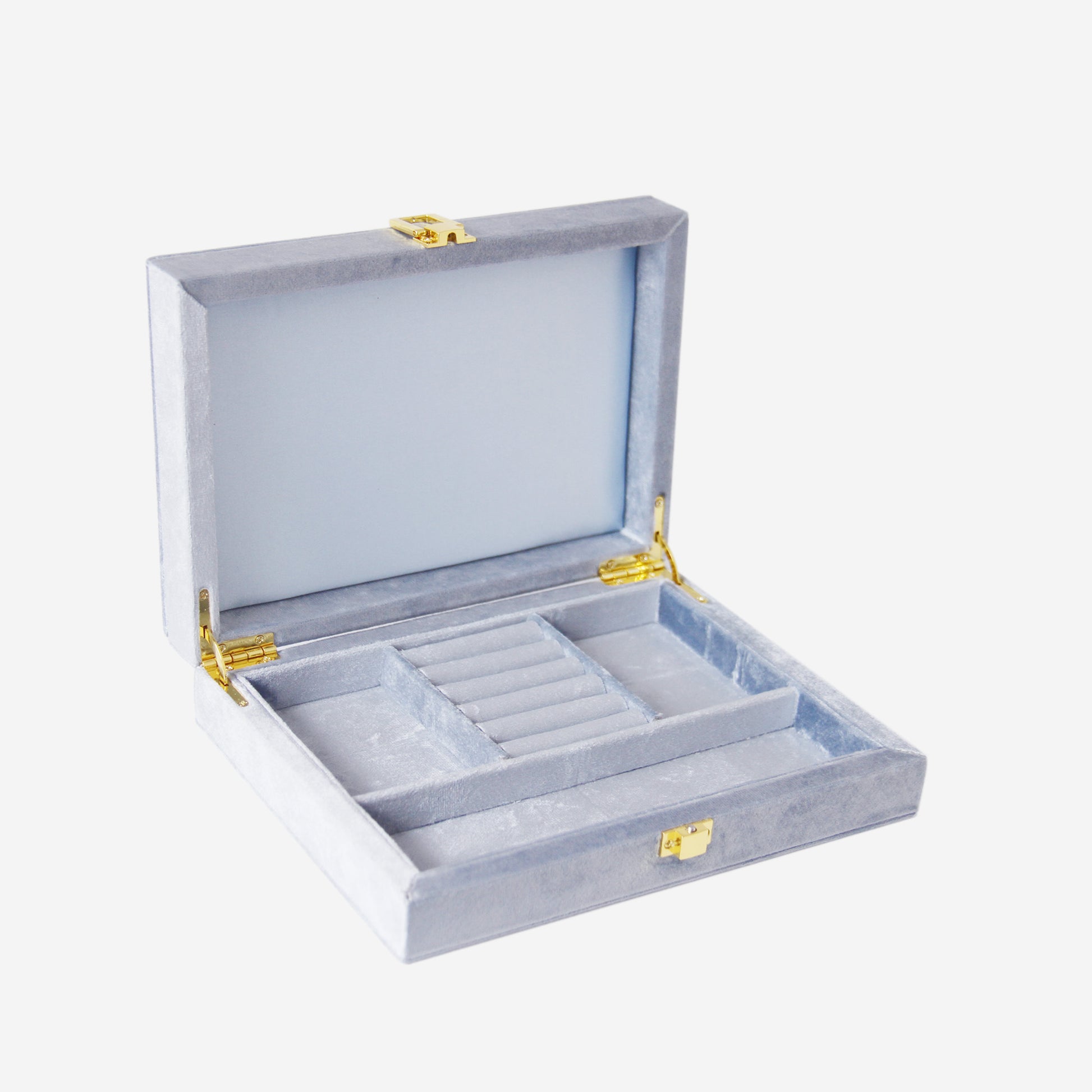 Open blue velvet jewelry box with compartments and gold hinges on an off white background