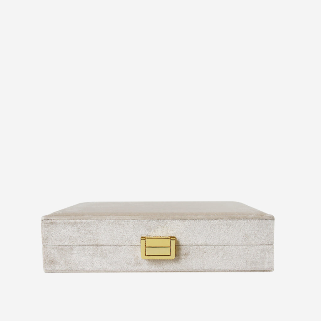 Champagne velvet closed jewellery box on an off white background