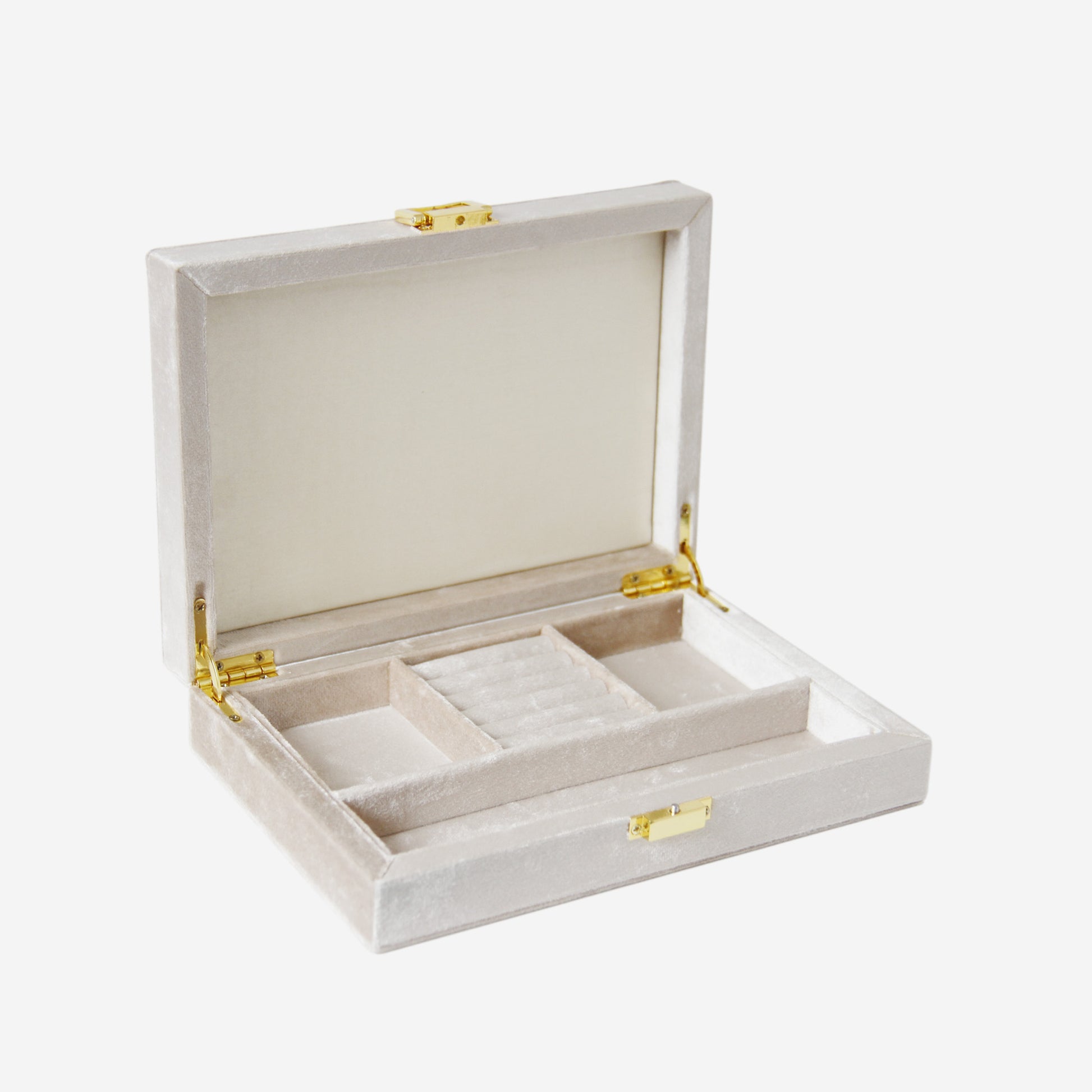 Open champagne velvet jewelry box with compartments and gold hinges on an off white background