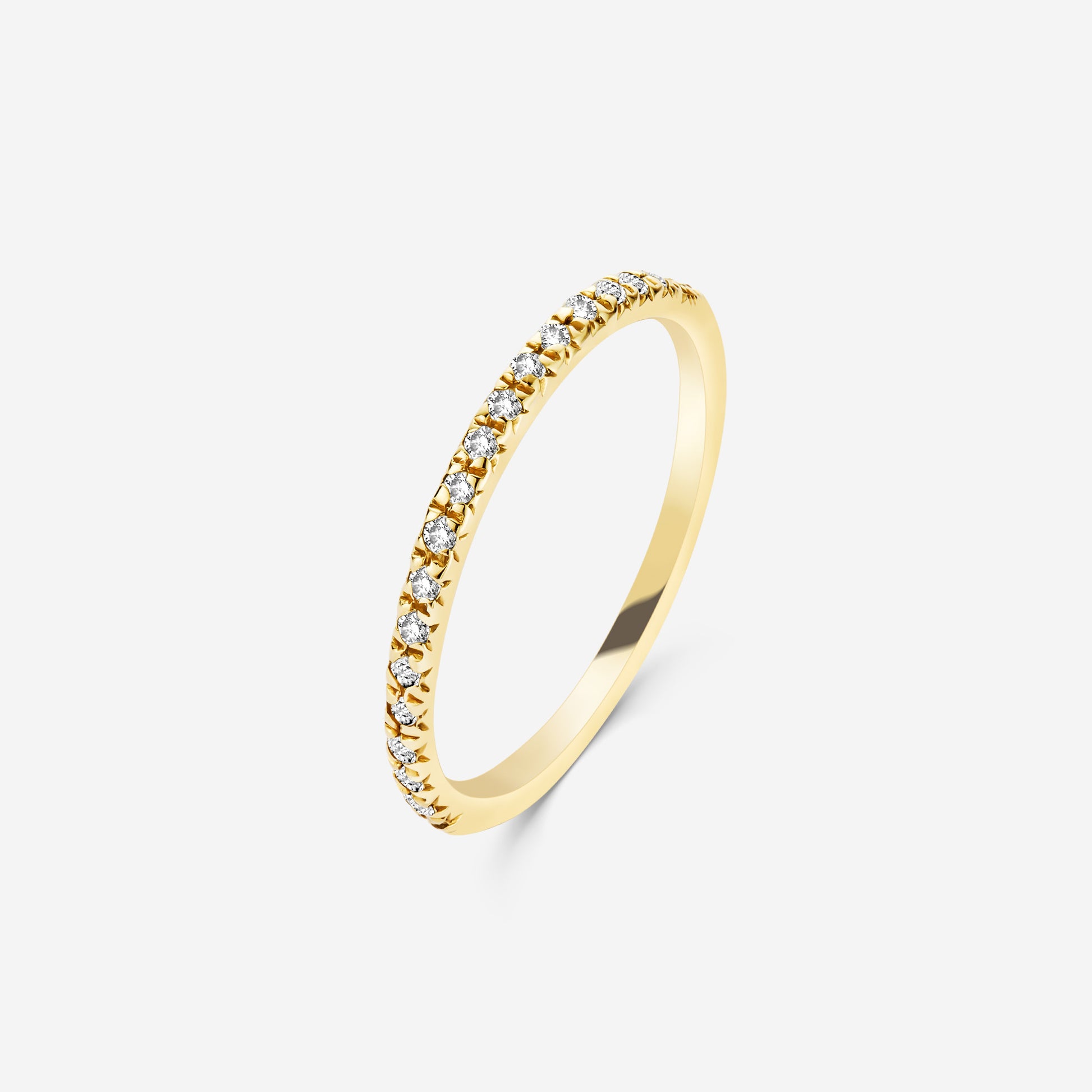 14ct yellow gold eternity ring with diamonds on an off white background