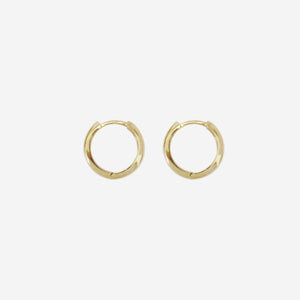 Pair of 14ct yellow gold huggy hoop earrings on an off white background