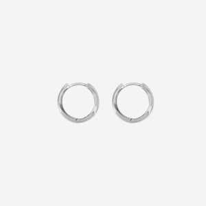 Pair of 14ct white gold huggy hoop earrings on an off white background
