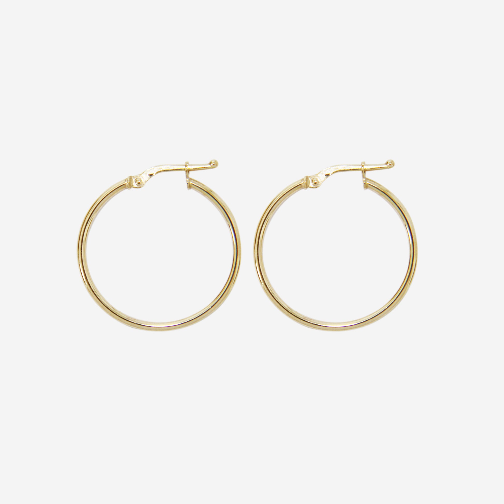 Pair of 14ct yellow gold medium hoop earrings on an off white background