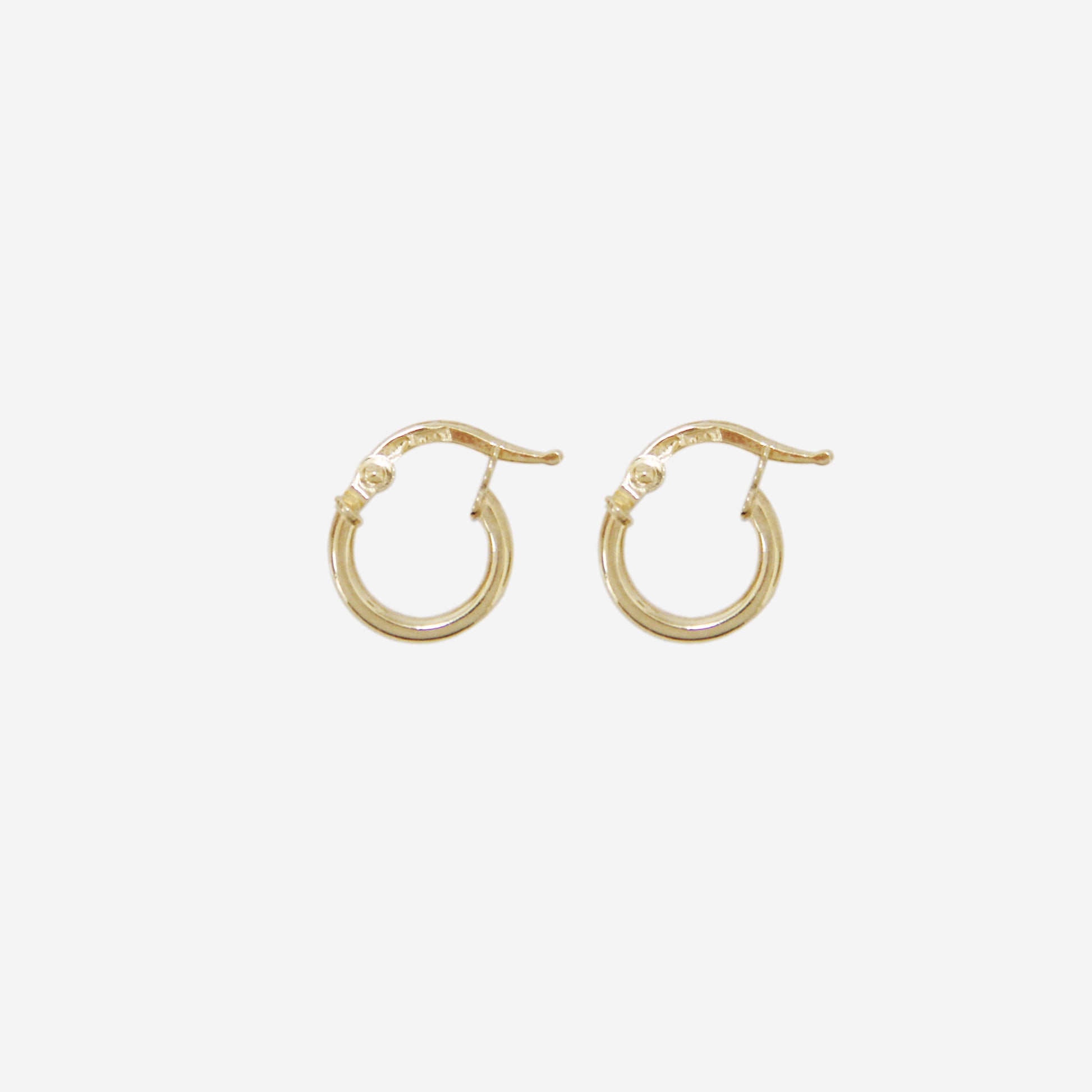Pair of 14ct yellow gold mini hoop earrings on an off white background