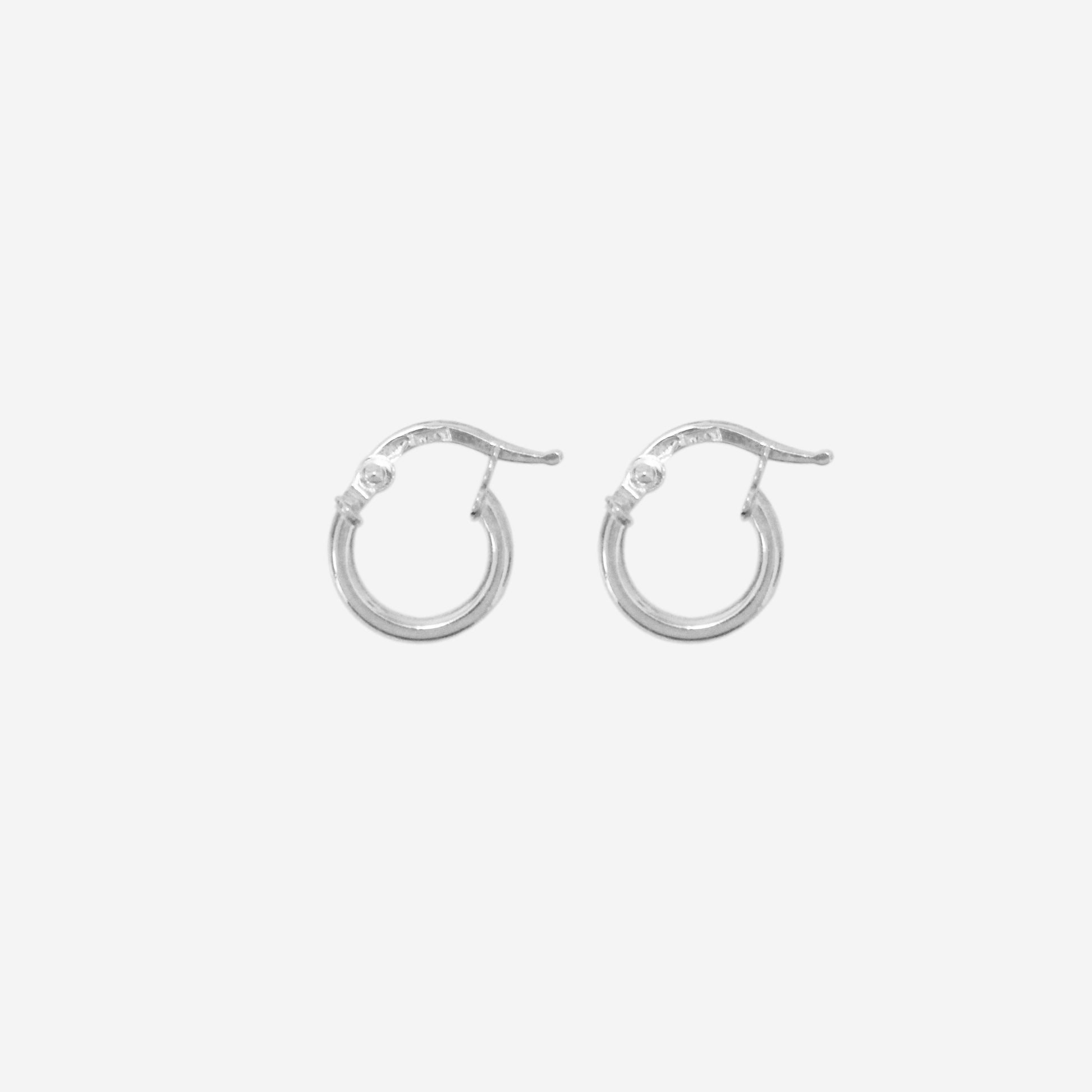 Pair of 14ct white gold mini hoop earrings on an off white background