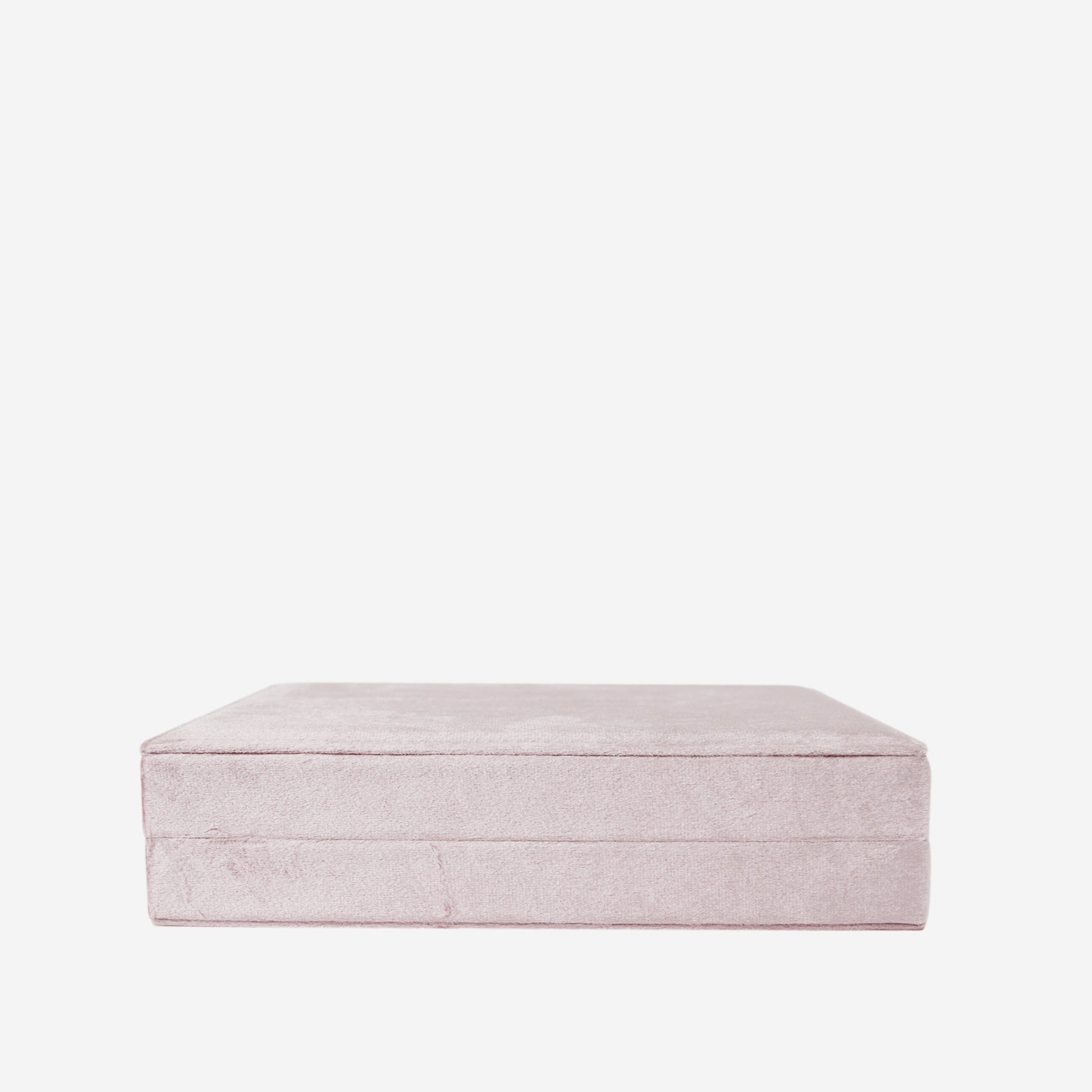 Pink velvet closed jewellery box on an off white background