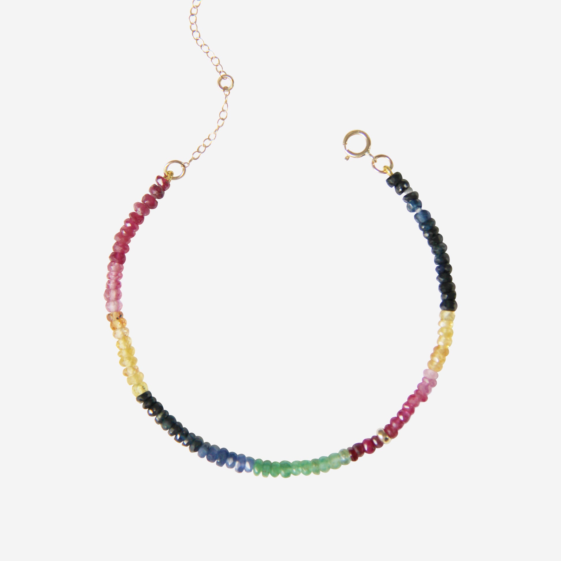 Rainbow beaded bracelet with multicolored beads on an off white background