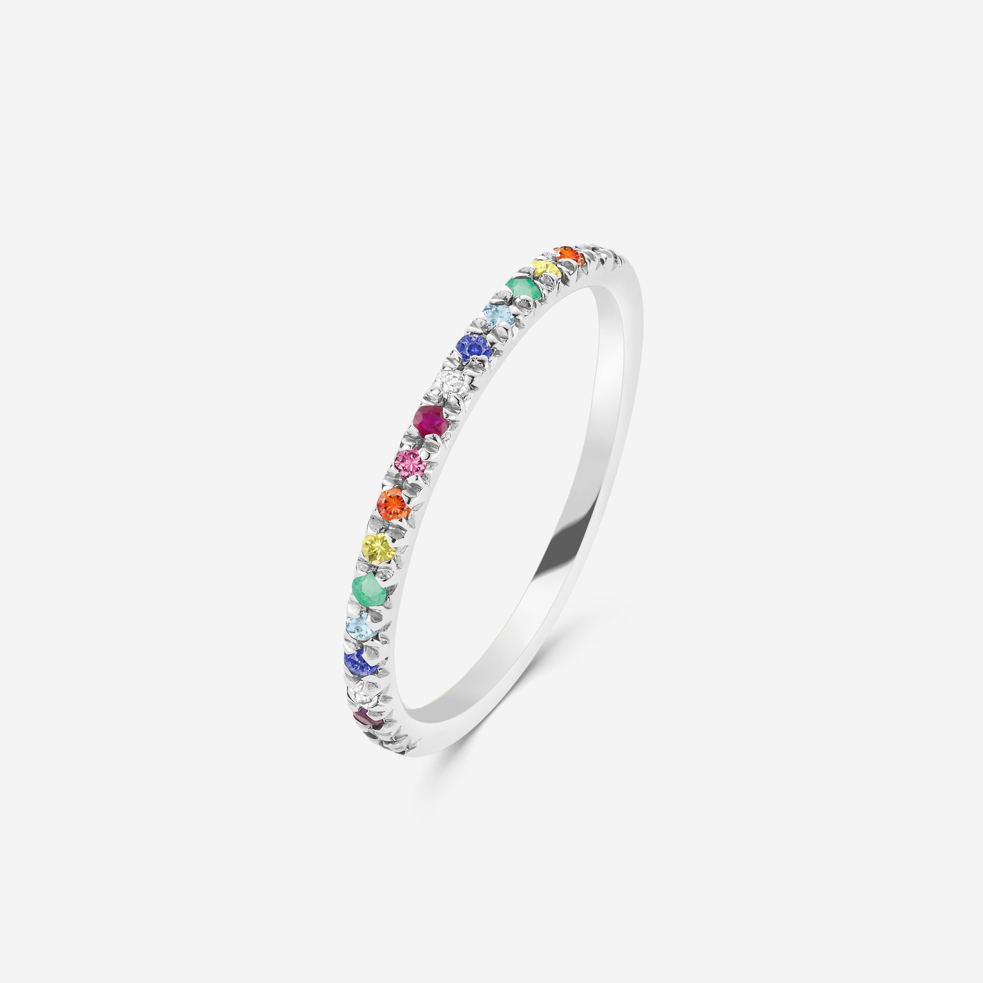 Silver  half eternity ring set with a rainbow of gemstones on an off white background