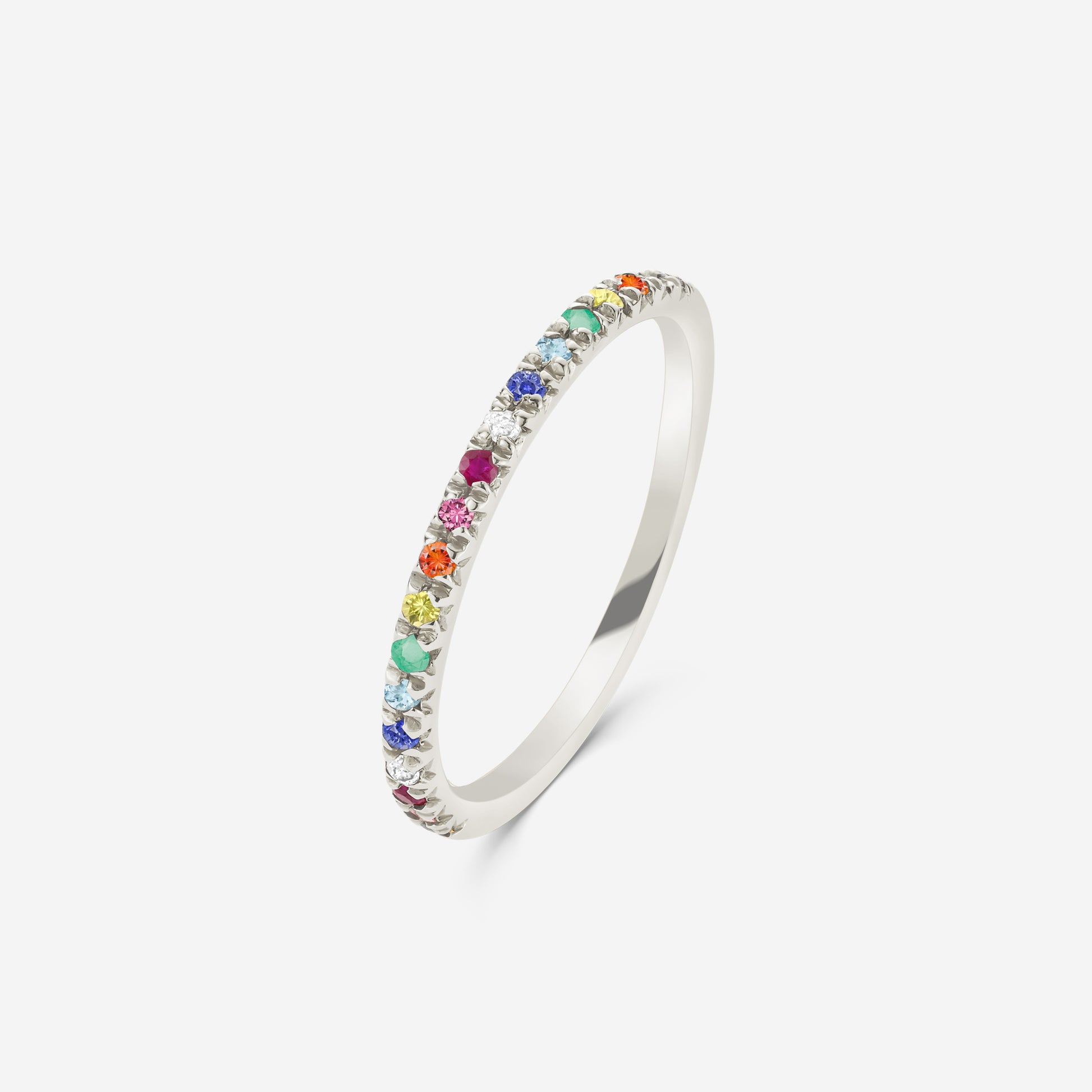 14ct white gold  half eternity ring set with a rainbow of gemstones on an off white background