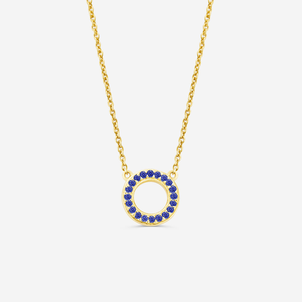 14ct yelllow gold eternity necklace with a circular pendant featuring blue sapphire gemstones stones on an off white background