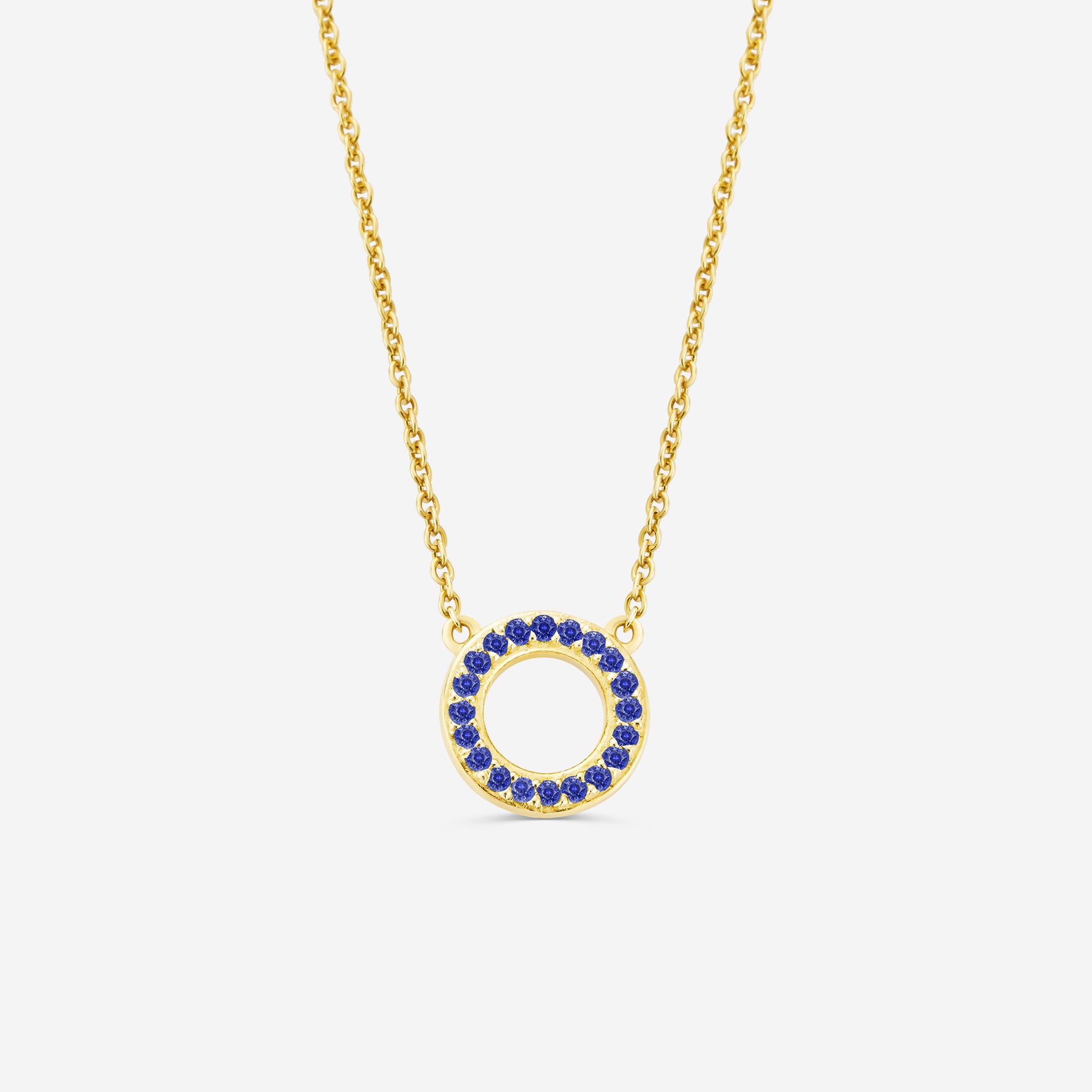 14ct yelllow gold eternity necklace with a circular pendant featuring blue sapphire gemstones stones on an off white background