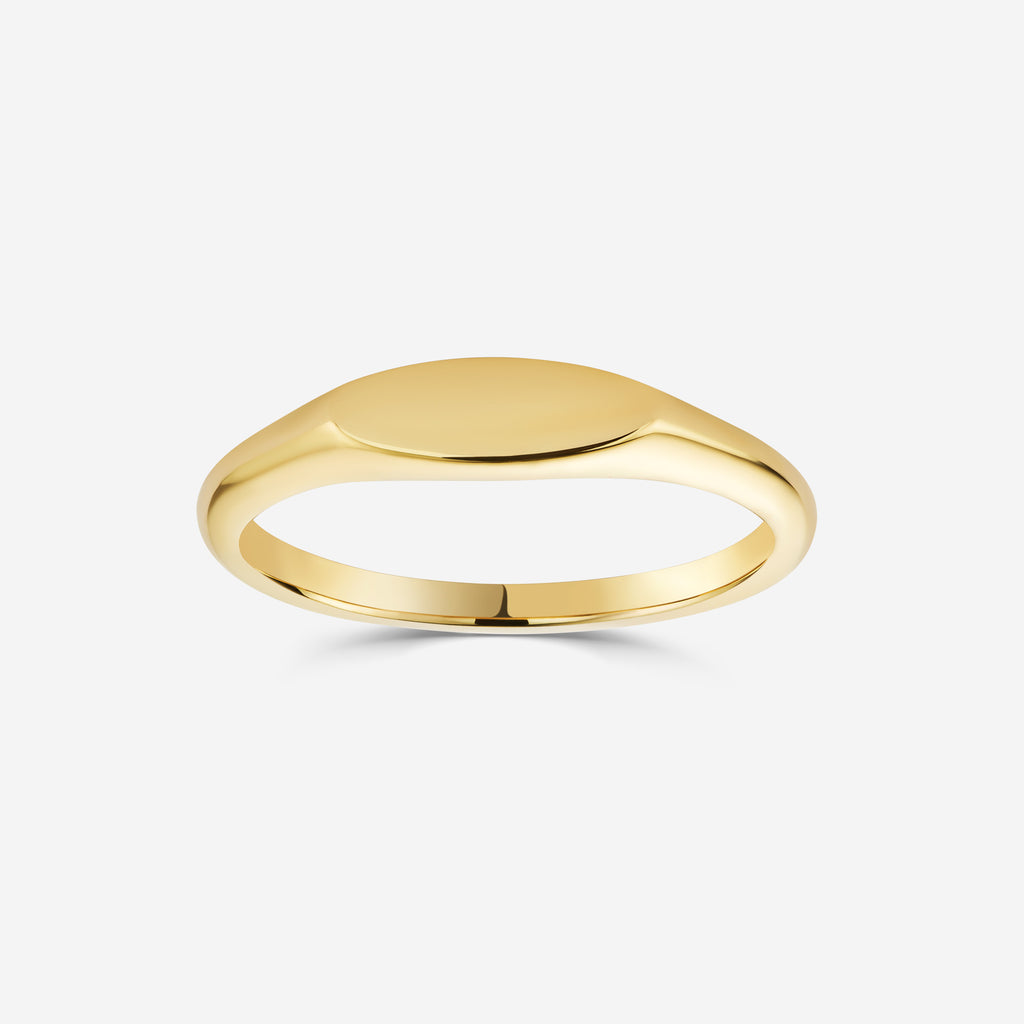9ct yellow gold oval signet ring on an off white background
