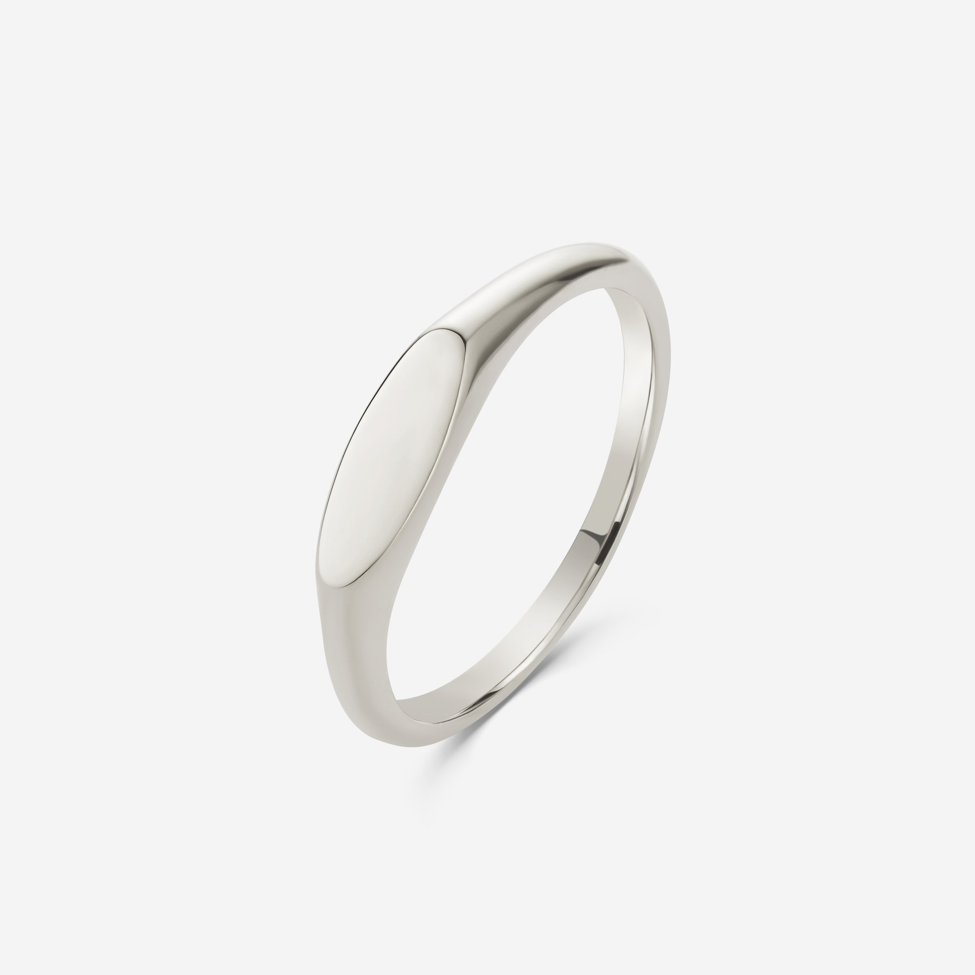 9ct white gold oval signet ring on an off white background