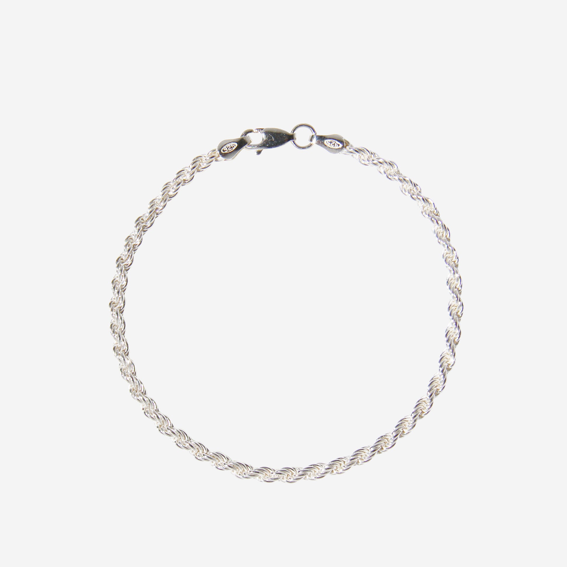 Silver rope chain bracelet on an off white background