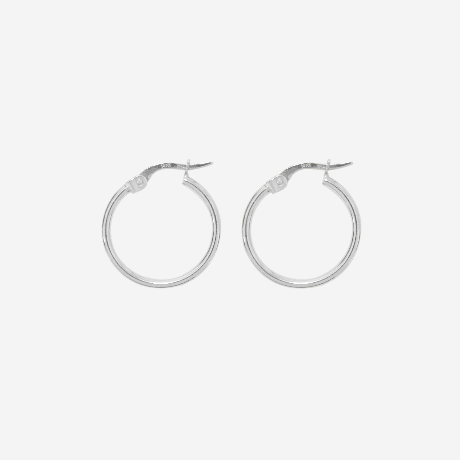 Pair of 14ct white gold small hoop earrings on an off white background