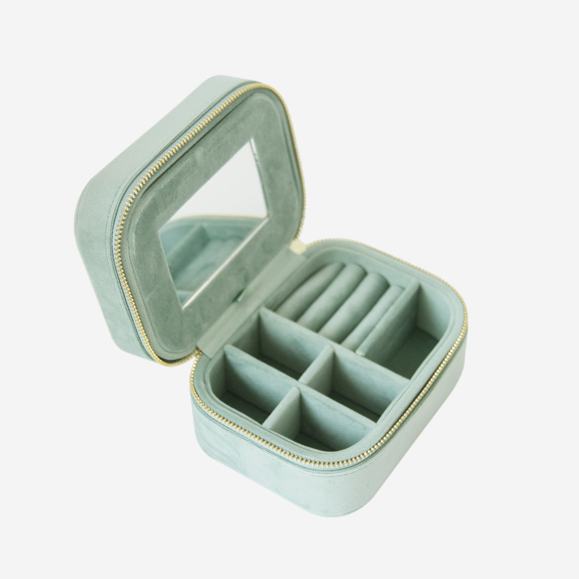 Green velet travel jewelry box with mirror on a white background