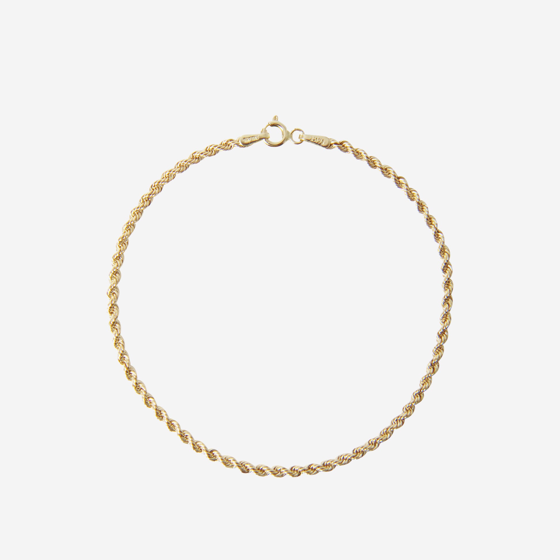 14ct yellow gold rope chain bracelet on an off white background